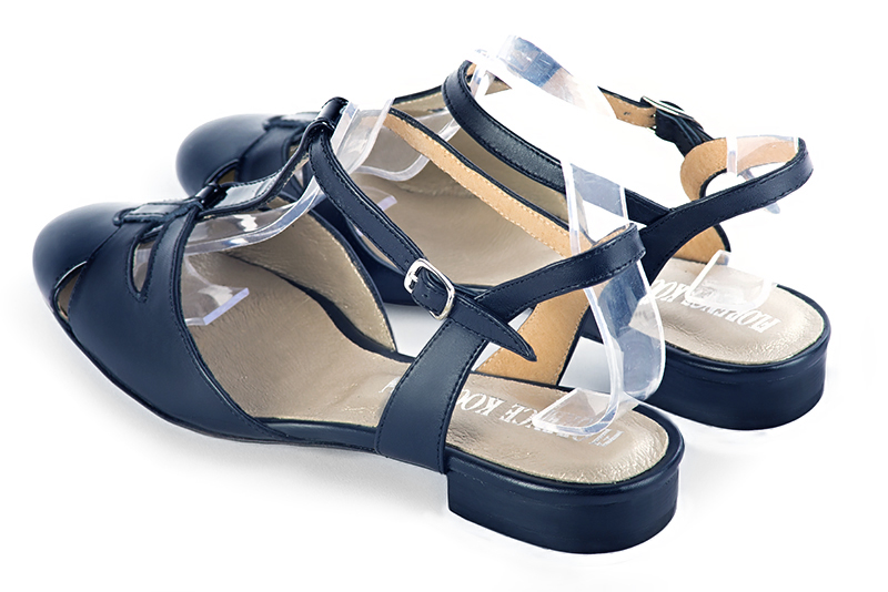Navy blue women's open back T-strap shoes. Round toe. Flat leather soles. Rear view - Florence KOOIJMAN
